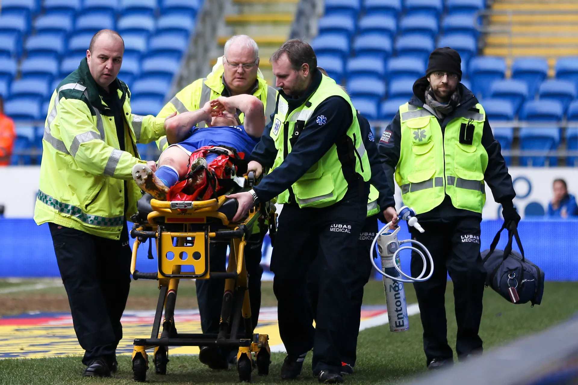 Pitch side medical team assisting an injured player at Cardiff city football club. 