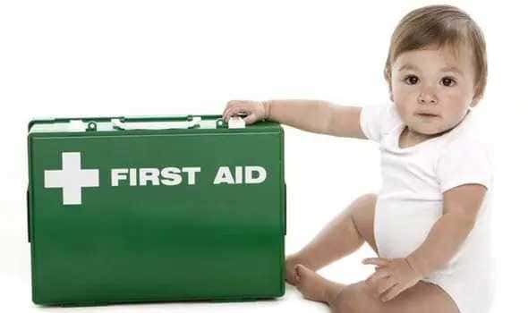 Baby holding first aid kit