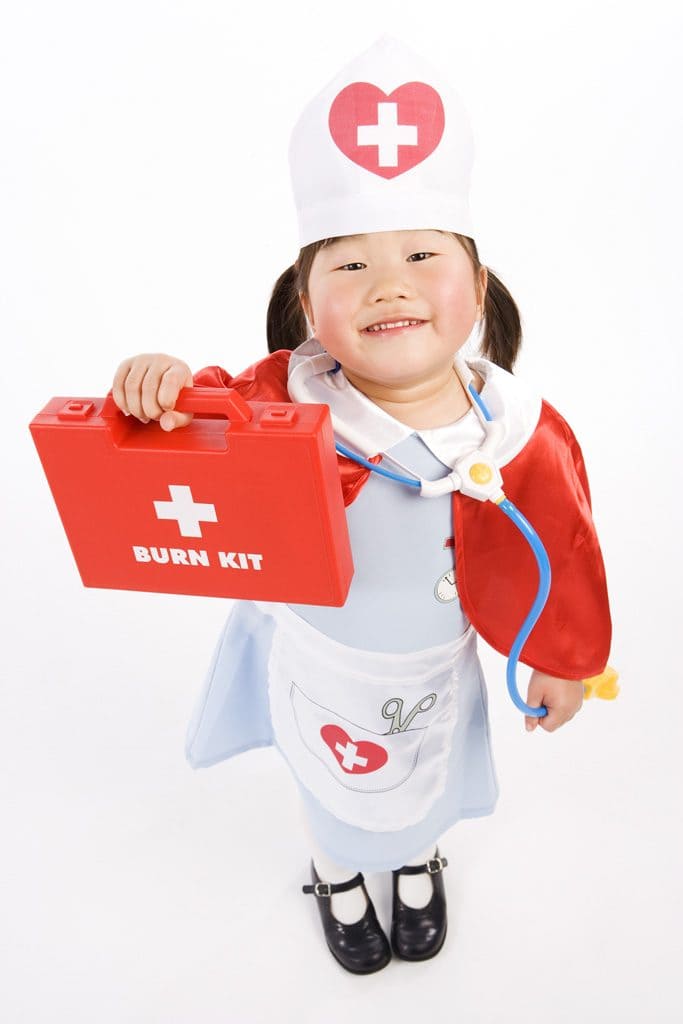 Child showing first aid kit