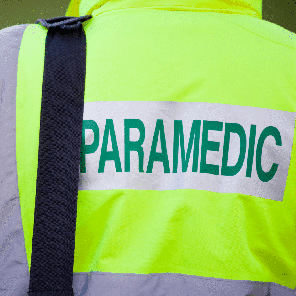 Back of a paramedic carrying a bag