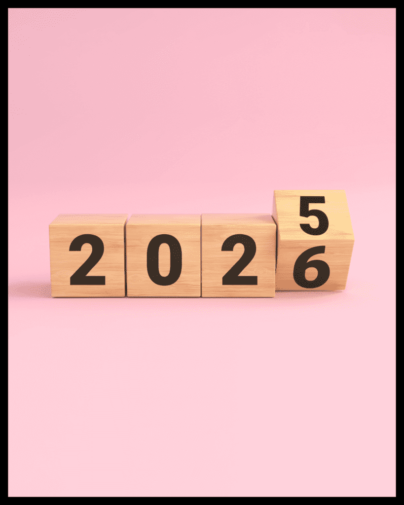 Wooden block countdown from 2025 to 2026 on a pink background